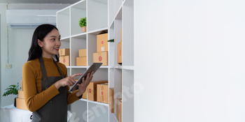 Woman managing inventory with tablet for online store