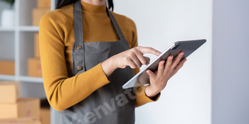 Woman using tablet to manage ecommerce inventory