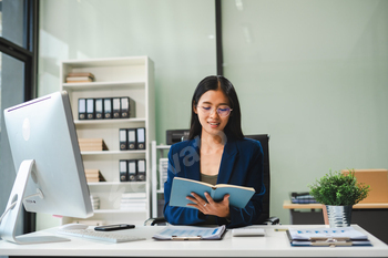 Business woman take notes and use the calculator with calculations about the expenses at the office.