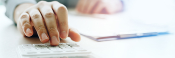 Hand man doing finances and calculate using calculator calculate budget on desk