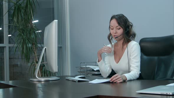 Young Beautiful Asian Businesswoman with Headset in Office