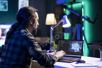 Man managing complex system on laptop