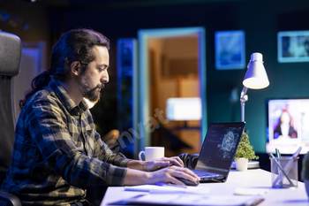 Man typing in machine code on laptop