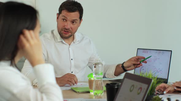 Male Chief Executive Talking to a Diverse Team of Professional Business People