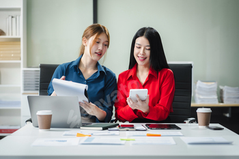 Businesswomen working with tablet and using a calculator to calculate the tax of static