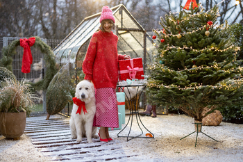 Woman with dog celebrates winter holidays