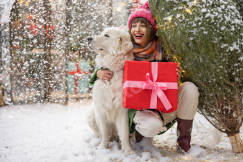 Woman with dog celebrates winter holidays