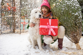 Woman with dog celebrates winter holidays