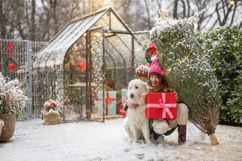 Woman with dog celebrates winter holidays