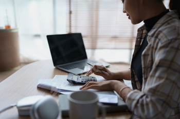 Smart Mortgage Planning woman using a calculator to make Calculations and Consideration