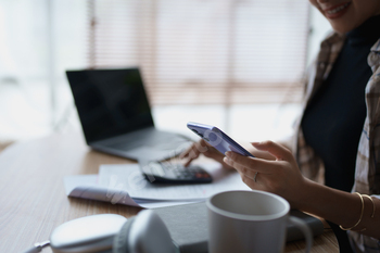 Smart Mortgage Planning woman using a calculator to make Calculations and Consideration