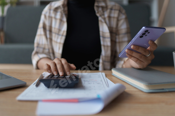 Smart Mortgage Planning woman using a calculator to make Calculations and Consideration