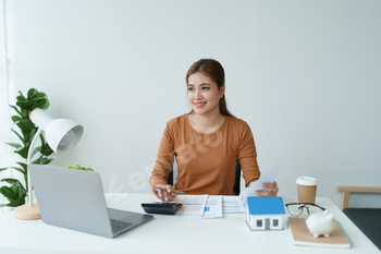 Smart Mortgage Planning woman using a calculator to make Calculations and Consideration