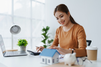 Smart Mortgage Planning woman using a calculator to make Calculations and Consideration