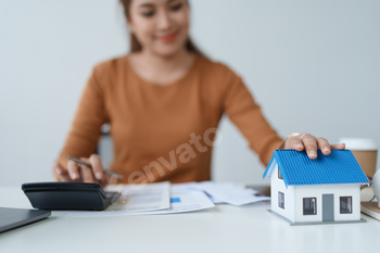 Smart Mortgage Planning woman using a calculator to make Calculations and Consideration