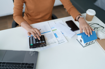 Smart Mortgage Planning woman using a calculator to make Calculations and Consideration