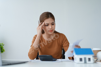 Smart Mortgage Planning woman using a calculator to make Calculations and Consideration