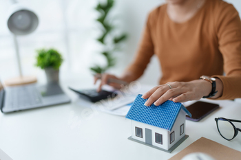 Smart Mortgage Planning woman using a calculator to make Calculations and Consideration