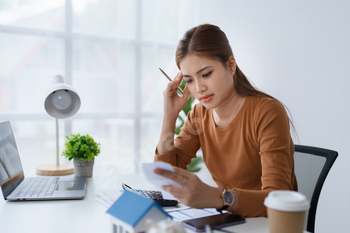 Smart Mortgage Planning woman using a calculator to make Calculations and Consideration