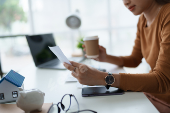 Smart Mortgage Planning woman using a calculator to make Calculations and Consideration