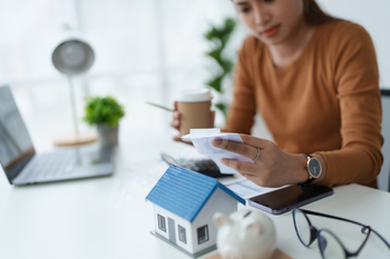 Smart Mortgage Planning woman using a calculator to make Calculations and Consideration