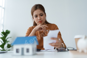 Smart Mortgage Planning woman using a calculator to make Calculations and Consideration