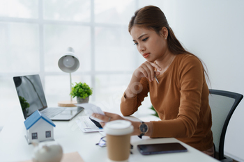 Smart Mortgage Planning woman using a calculator to make Calculations and Consideration