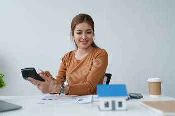 Smart Mortgage Planning woman using a calculator to make Calculations and Consideration