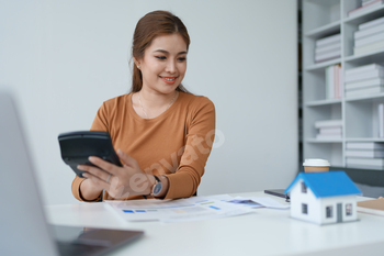 Smart Mortgage Planning woman using a calculator to make Calculations and Consideration