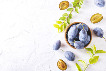 fresh plum fruit in bowl