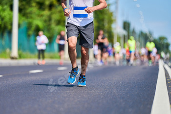 Marathon runners on city road.