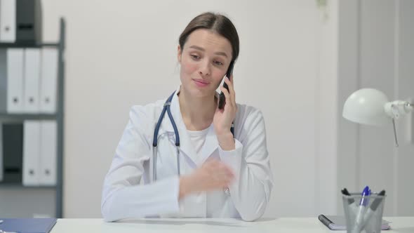 Female Doctor Talking on Smartphone 