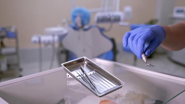 Set of dentist tools on dental cabinet background: dentist mirror, forceps curved