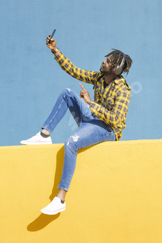 black man with headphones making a video call