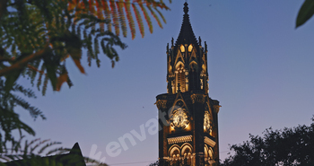 Rajabai Clock Tower In Evening Illumination. Clock Tower In Mumbai India. Confines Of Fort Campus Of