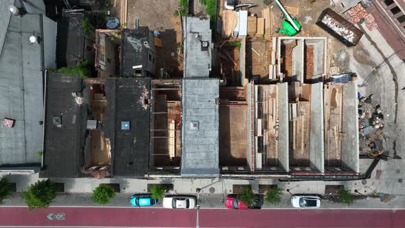 Top down aerial of home without roof. Disrepair and crime in urban city setting. Abandoned rowhouses