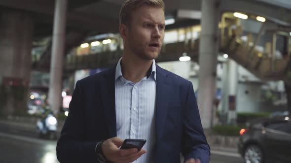 Businessman checking samrtphone, Bangkok, Thailand