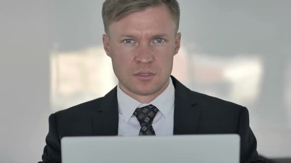 Portrait of Businessman Inviting Customers in Office