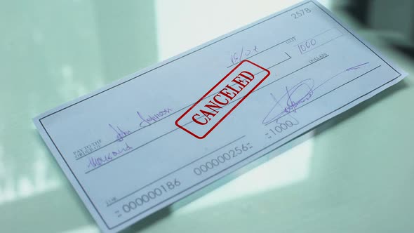 Cheque Document Canceled, Hand Stamps Seal on Official Paper, Insufficient Funds