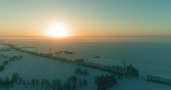 Aerial Drone View of Cold Winter Landscape with Arctic Field, Trees Covered with Frost Snow and