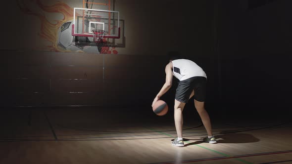 Slowmo of Basketball Player Dribbling and Shooting Ball