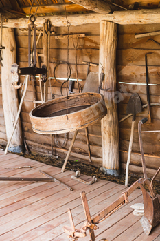 Antique farming tools in a rustic wooden barn