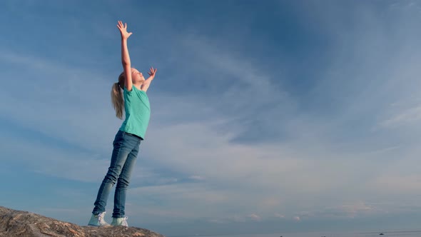 Relaxed Girl Breathing Fresh Air Raising Arms Over Blue Sky at Summer