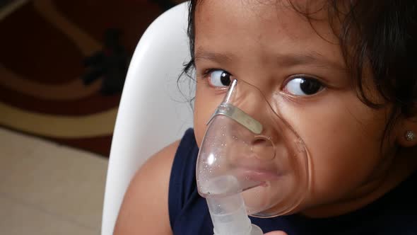 Asian girl is being nebulized to cure her respiratory tract. Close up shoot