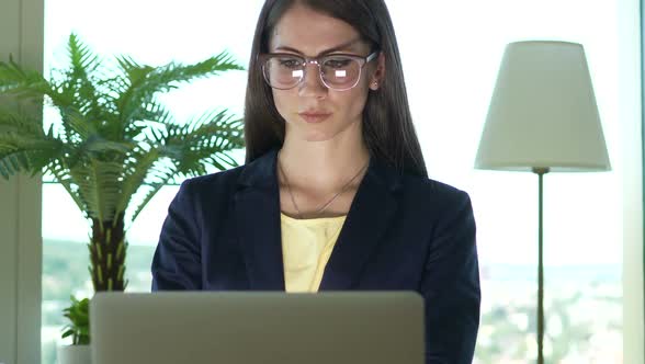 Confident Attractive Business Woman Working on Computer Desk