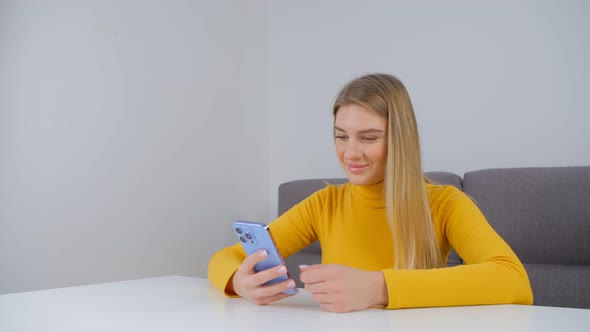 Cheerful blonde female using modern smartphone for online communication in 4k footage
