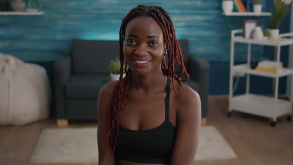 Portrait of Fit Woman Smiling and Looking Into Camera During Aerobic Morning Workout