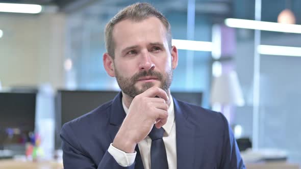 Portrait of Young Businessman Thinking and Get Idea