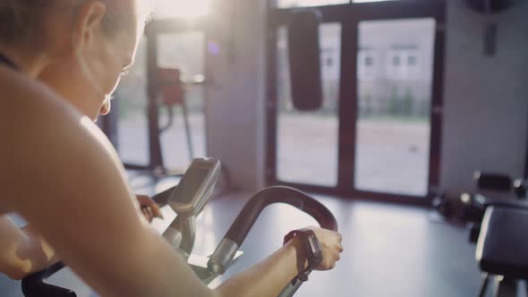 Handheld view of athlete working out with exercise bike.  Shot with RED helium camera in 8K