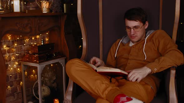 Young Man in Glasses Reading Book